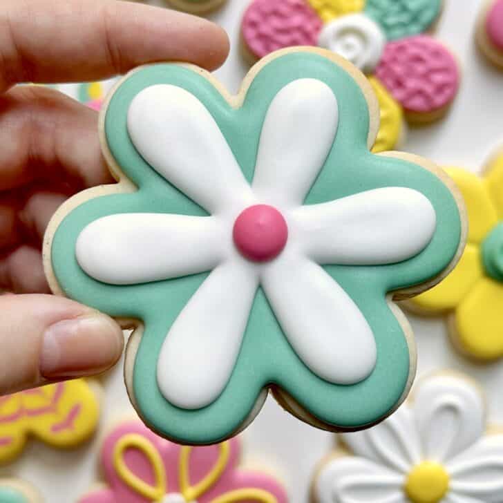 teal flower cookies decorated with royal icing