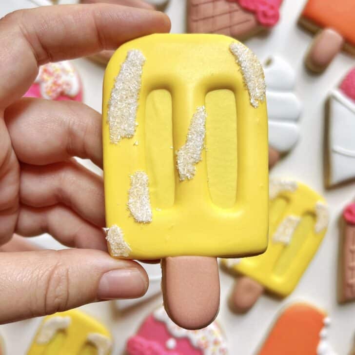yellow popsicle cookie decorated with royal icing 