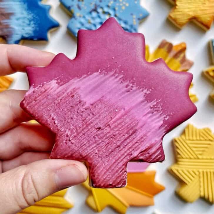 swipe maple leaf cookies decorated with royal icing 