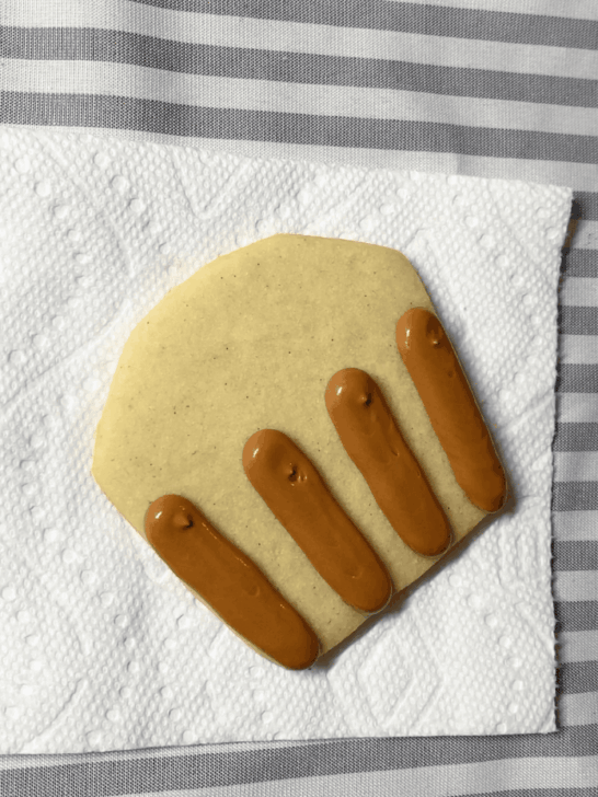 Step-by-step decorating instructions for how to decorate Apple basket cookies with royal icing