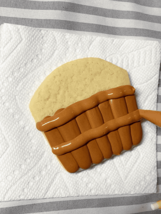 Step-by-step decorating instructions for how to decorate Apple basket cookies with royal icing