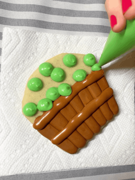 Step-by-step decorating instructions for how to decorate Apple basket cookies with royal icing