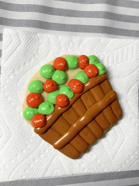 Step-by-step decorating instructions for how to decorate Apple basket cookies with royal icing