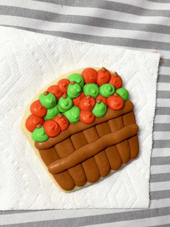 Step-by-step decorating instructions for how to decorate Apple basket cookies with royal icing