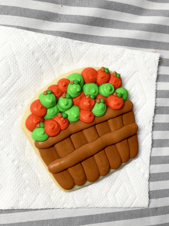 Step-by-step decorating instructions for how to decorate Apple basket cookies with royal icing