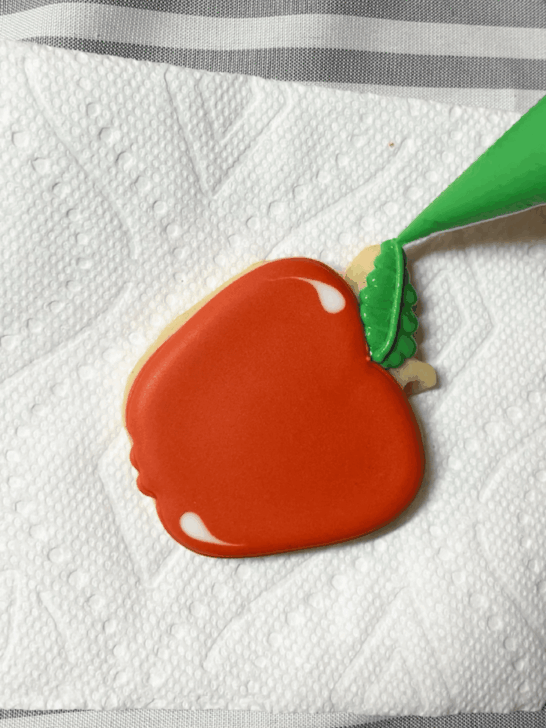 Step-by-step decorating instructions for how to decorate apple decorated cookies with releasing
