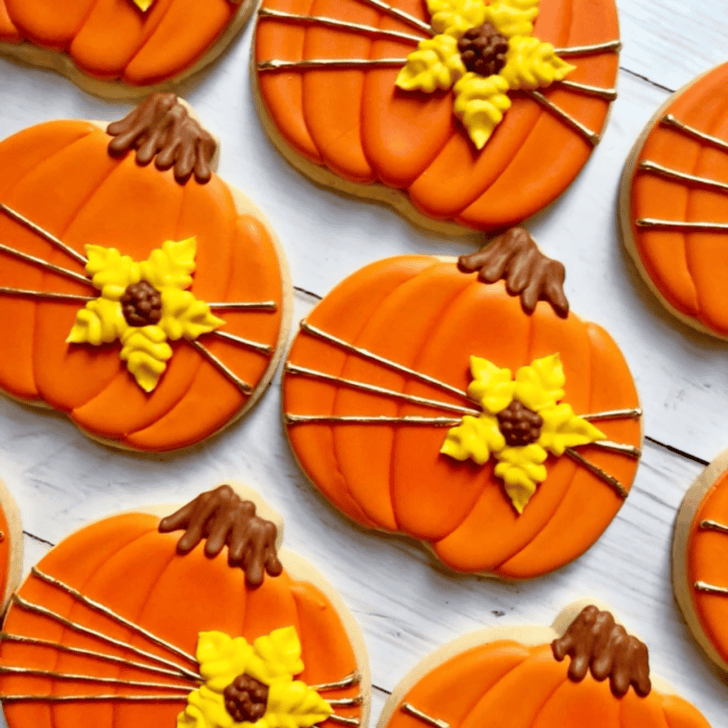 pumpkin shaped cookies decorated with royal icing
