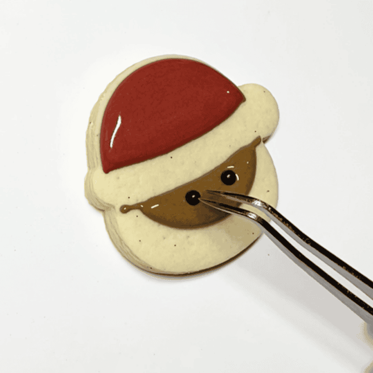 step 3 for decorating a santa cookie with royal icing