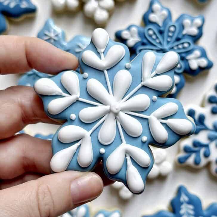 light blue snowflake cookie decorated with royal icing 