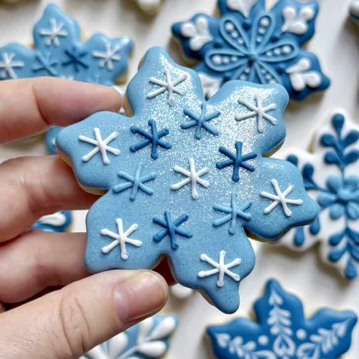 light blue snowflake cookie decorated with royal icing 