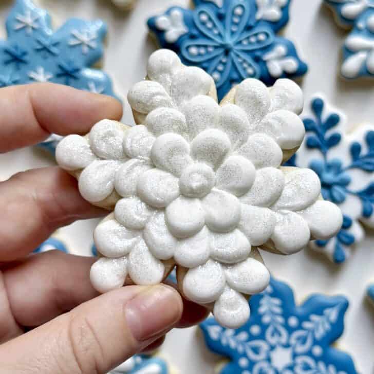 white snowflake cookie decorated with royal icing 