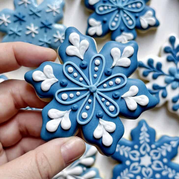 dark blue snowflake cookie decorated with royal icing 