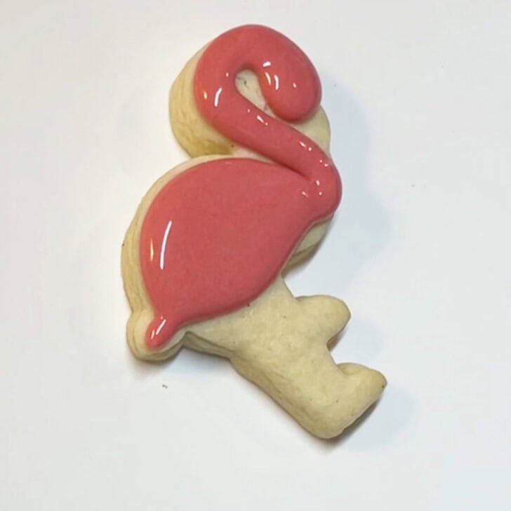 Step-by-step instructions for how to decorate flamingo cookies with royal icing
