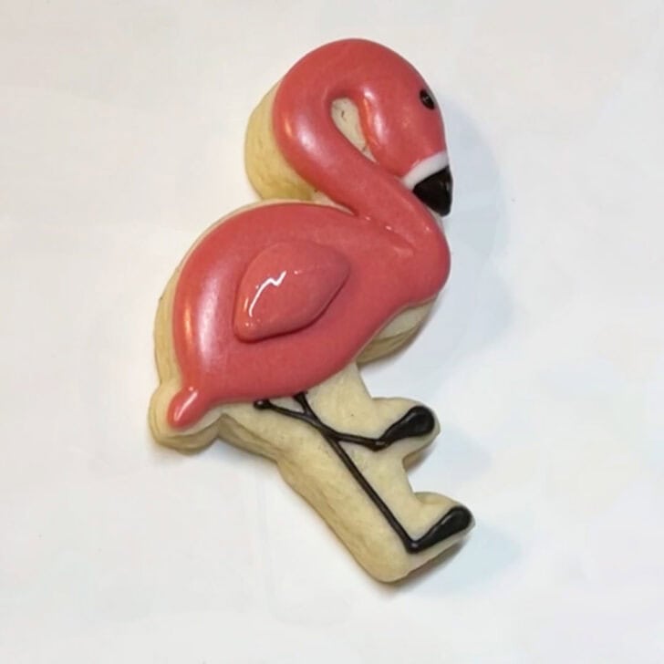 Step-by-step instructions for how to decorate flamingo cookies with royal icing