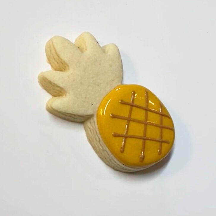 Step-by-step instructions for decorated pineapple cookies with royal icing