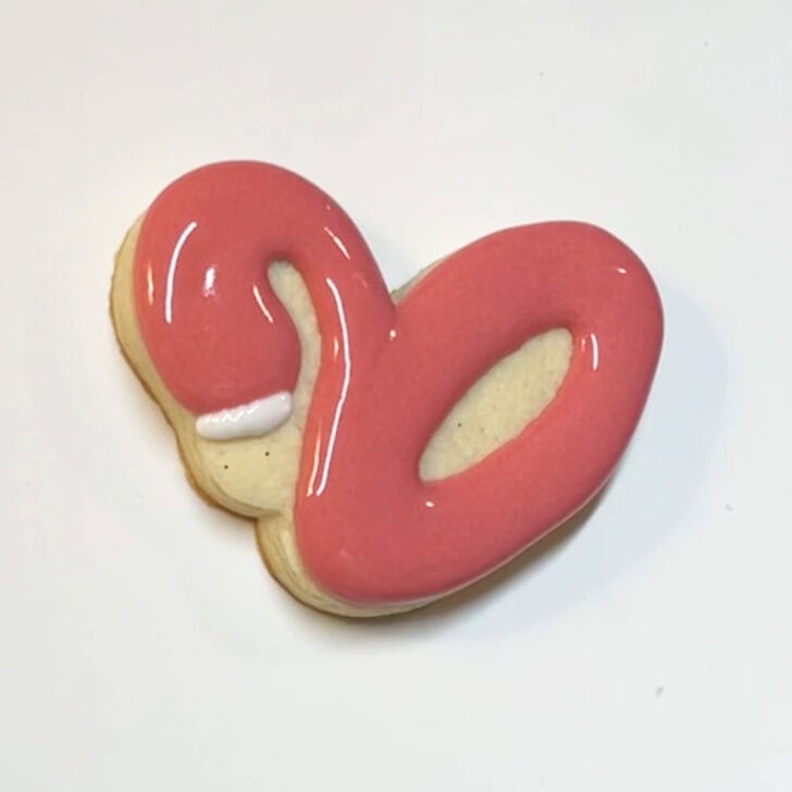 Step-by-step instructions for how to decorate flamingo pool float cookies with royal icing