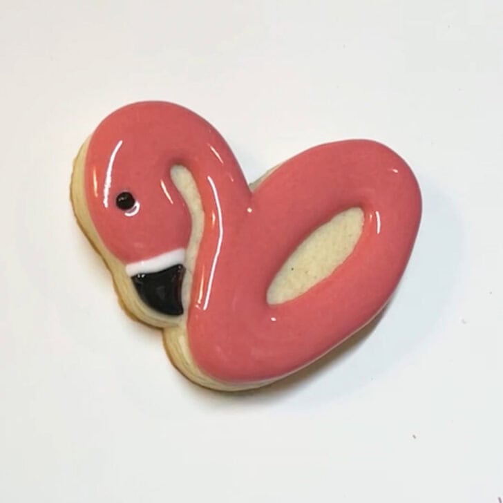 Step-by-step instructions for how to decorate flamingo pool float cookies with royal icing