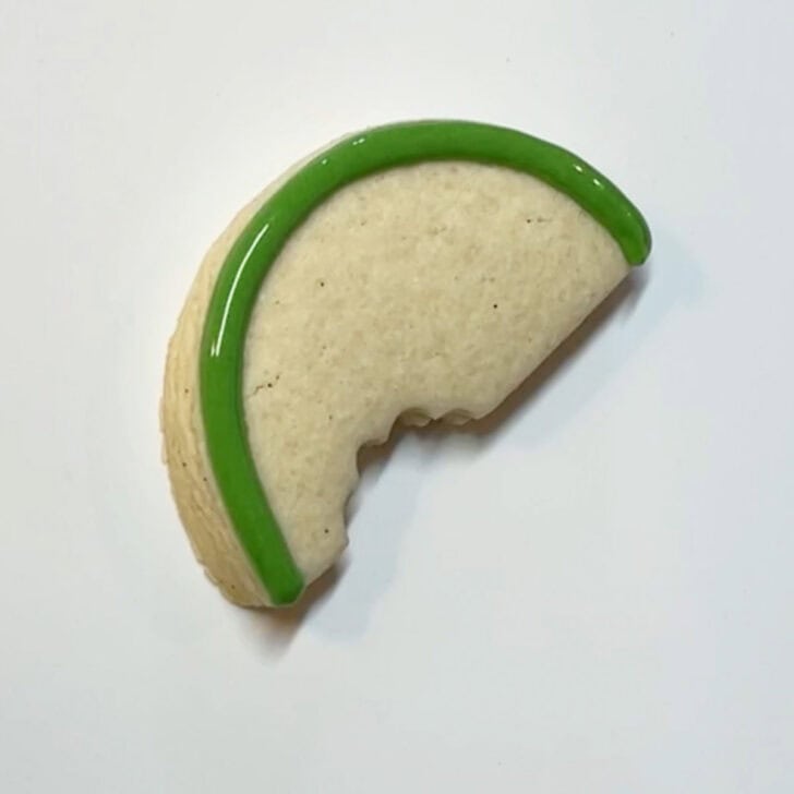 Step-by-step instructions for how to decorate watermelon cookies with royal icing