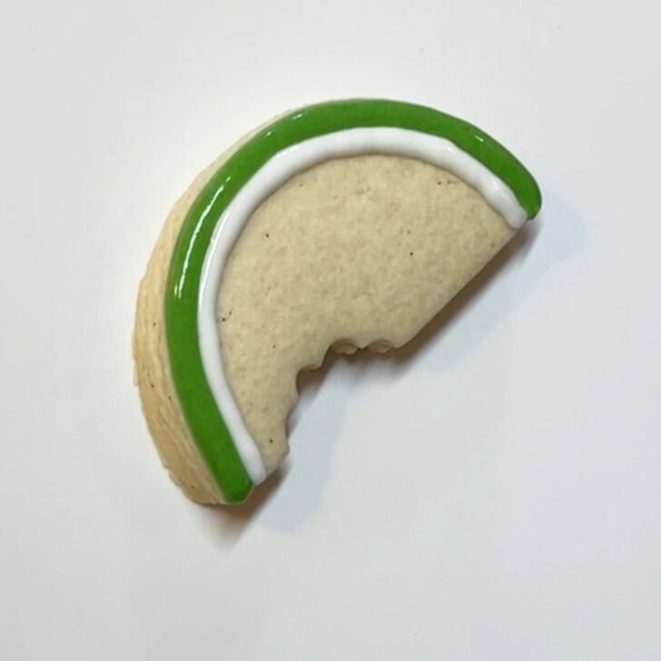 Step-by-step instructions for how to decorate watermelon cookies with royal icing