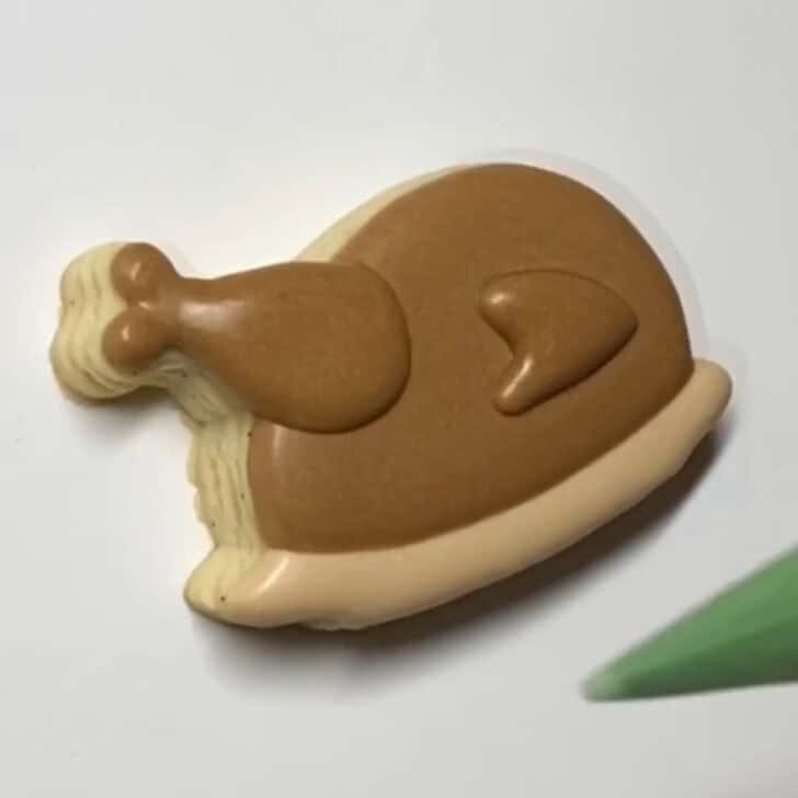 Step-by-step decorating instructions for how to decorate mini turkey sugar cookies with royal icing