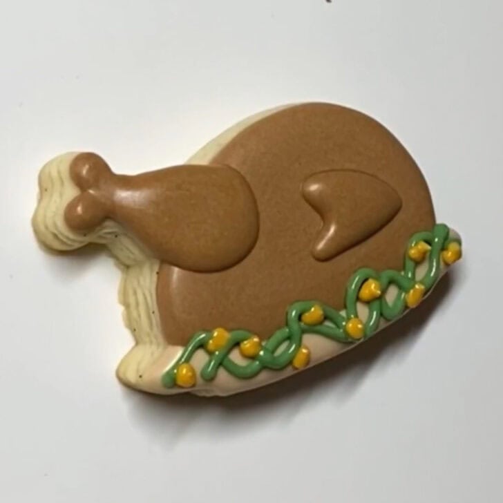 Step-by-step decorating instructions for how to decorate mini turkey sugar cookies with royal icing