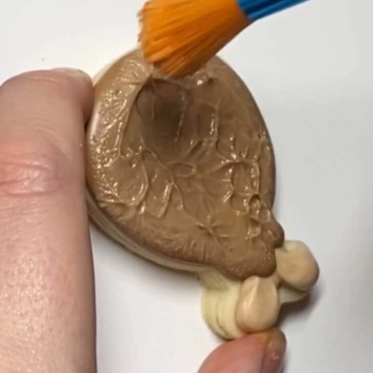 Step-by-step decorating instructions for how to decorate mini turkey leg cookies with royal icing