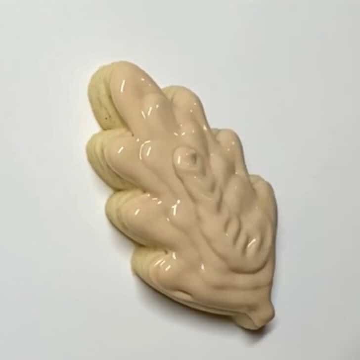 Step-by-step decorating instructions for how to decorate mini wheat sugar cookies with royal icing