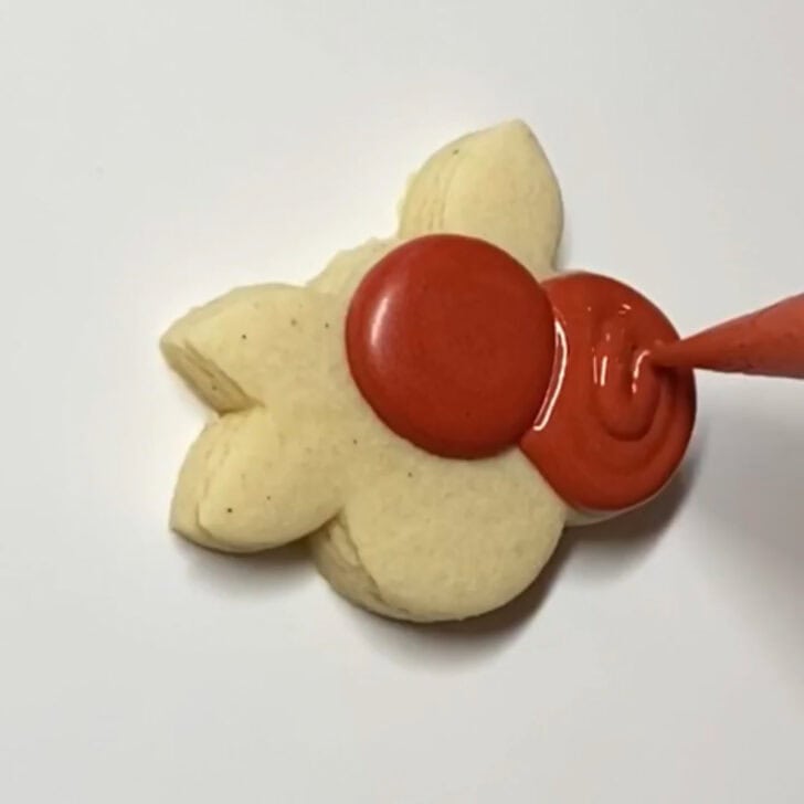 Step-by-step decorating instructions for how to decorate mini cranberry sugar cookies with royal icing