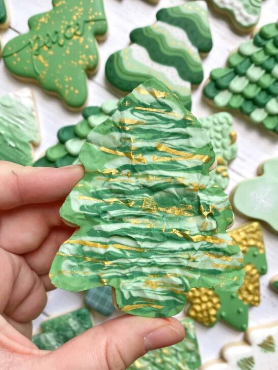 crinkled parchment Christmas tree cookies decorated with royal icing