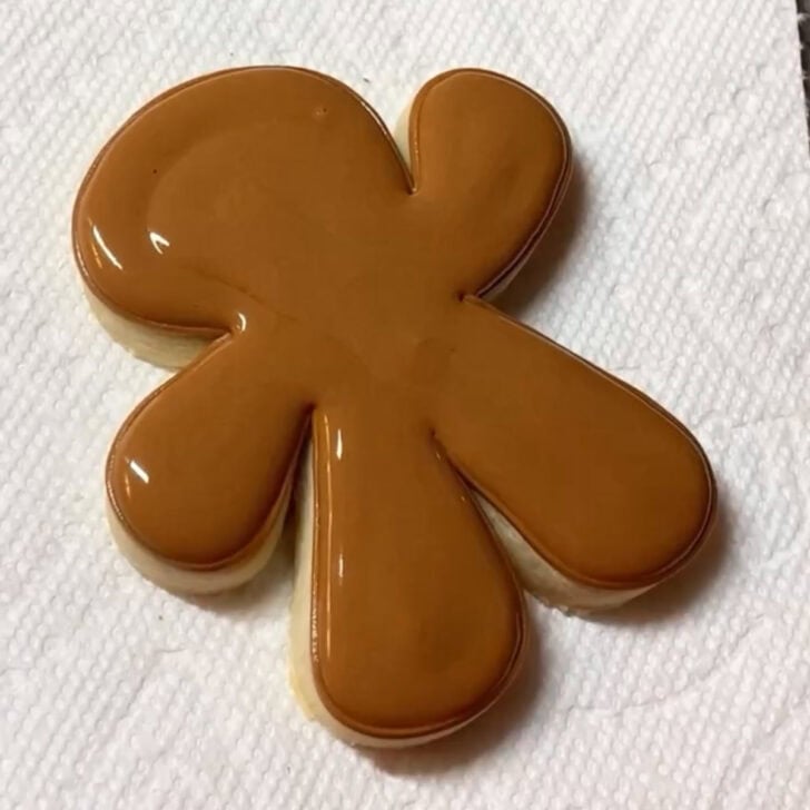 Stop by stop decorating instructions for how to decorate gingerbread man sugar cookies with royal icing