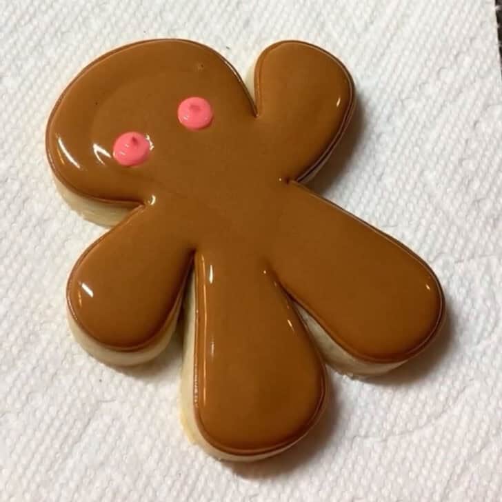 Stop by stop decorating instructions for how to decorate gingerbread man sugar cookies with royal icing