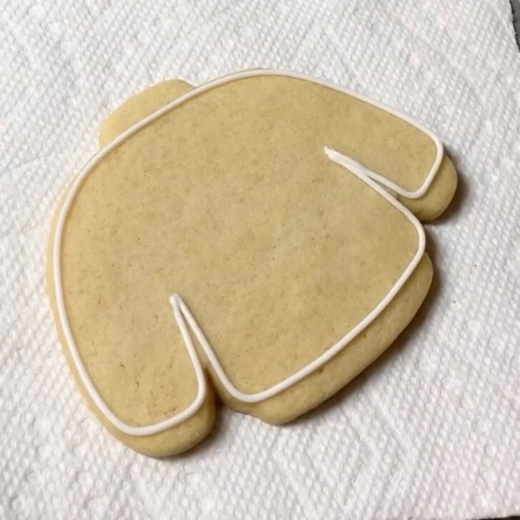 step by step decorating instructions for how to decorate sweater cookies with royal icing