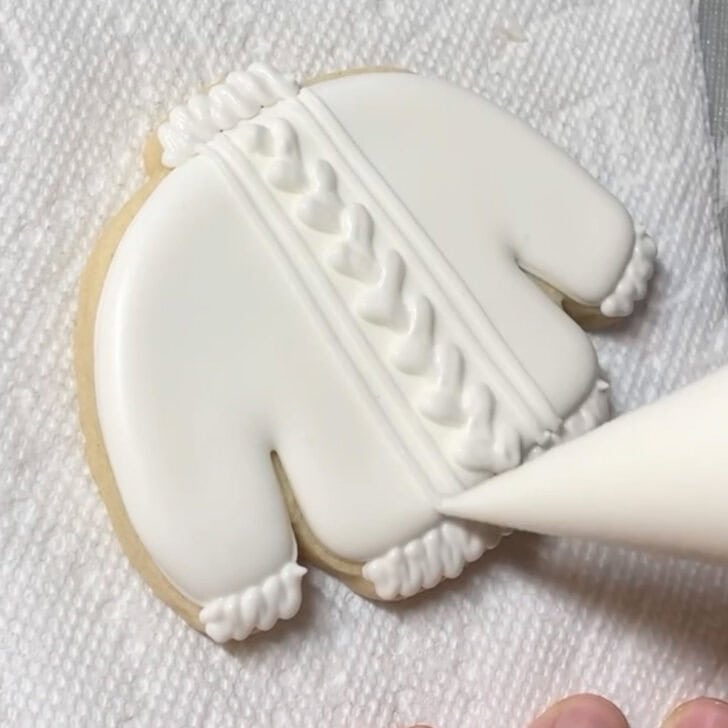 step by step decorating instructions for how to decorate sweater cookies with royal icing