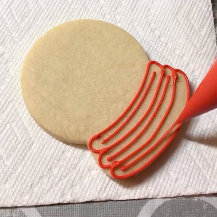 Step by step decorating instructions for how to decorate snow globe cookies with royal icing