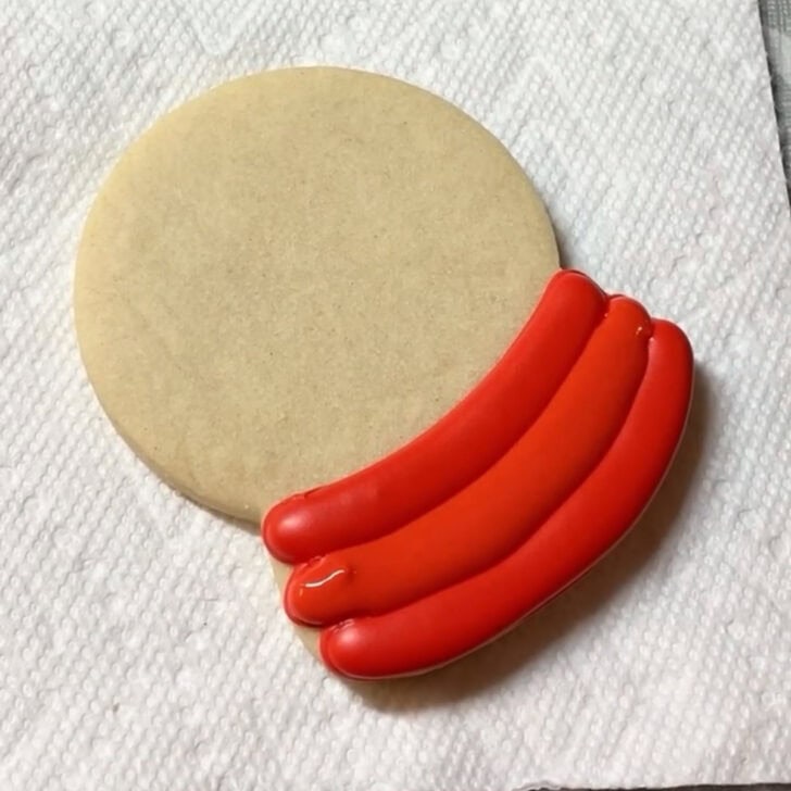 Step by step decorating instructions for how to decorate snow globe cookies with royal icing