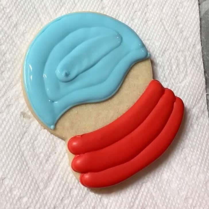 Step by step decorating instructions for how to decorate snow globe cookies with royal icing