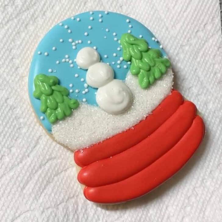 Step by step decorating instructions for how to decorate snow globe cookies with royal icing