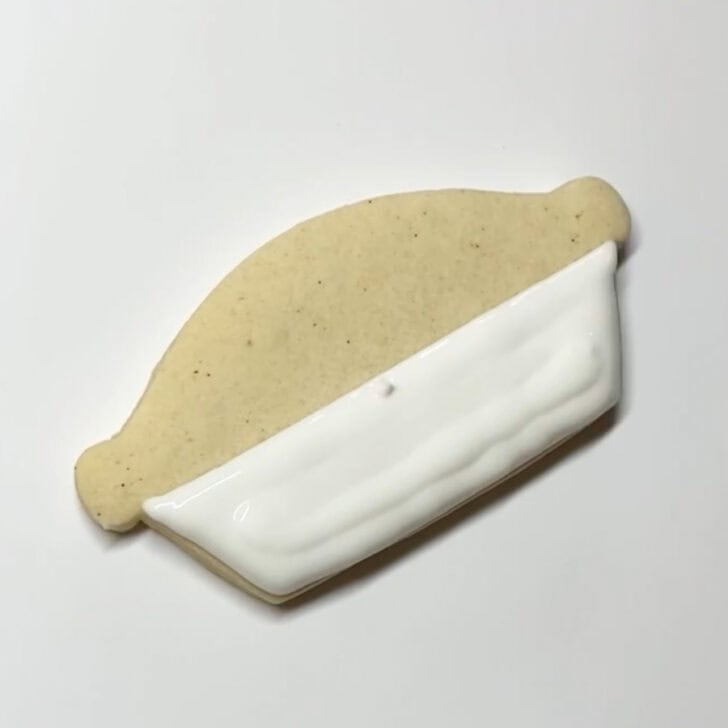 Step-by-step decorating instructions for how to decorate pecan pie sugar cookies with royal icing