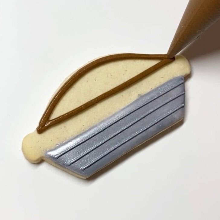 Step-by-step decorating instructions for how to decorate pecan pie sugar cookies with royal icing