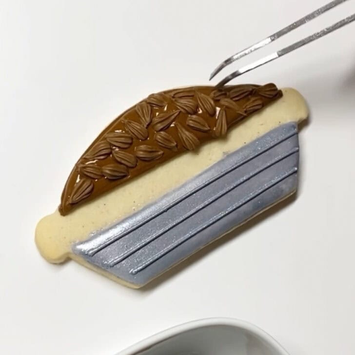 Step-by-step decorating instructions for how to decorate pecan pie sugar cookies with royal icing