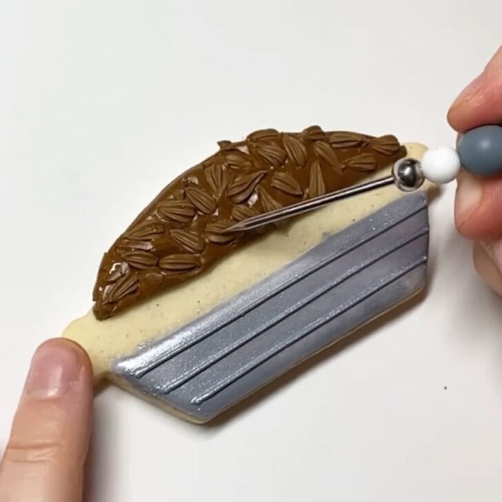 Step-by-step decorating instructions for how to decorate pecan pie sugar cookies with royal icing
