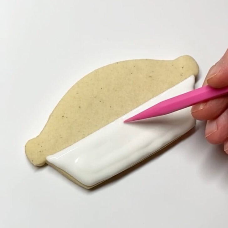 Step-by-step decorating instructions for how to decorate blueberry pie cookies with royal icing