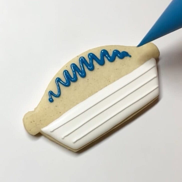 Step-by-step decorating instructions for how to decorate blueberry pie cookies with royal icing