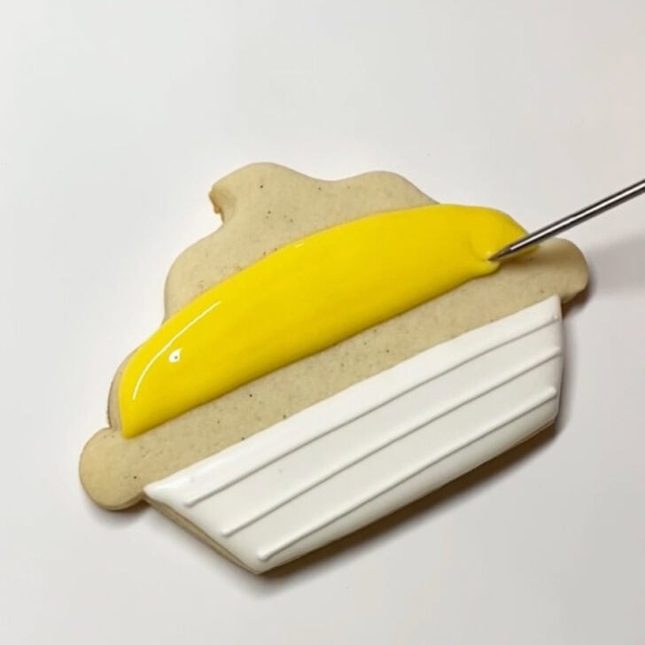 Step-by-step decorating instructions for how to decorate lemon pie cookies with royal icing