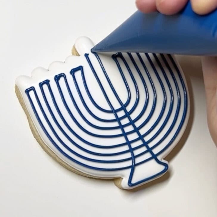 Step-by-step decorating instructions for how to decorate menorah cookies with royal icing
