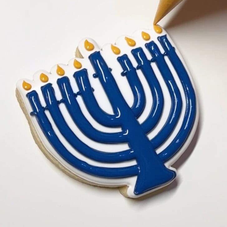 Step-by-step decorating instructions for how to decorate menorah cookies with royal icing