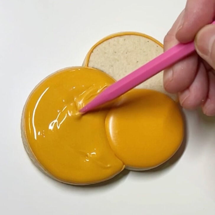 Step-by-step decorating instructions for how to decorate Hanukkah gelt cookies with royal icing