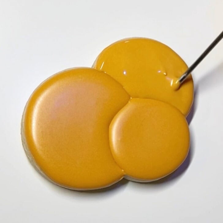 Step-by-step decorating instructions for how to decorate Hanukkah gelt cookies with royal icing