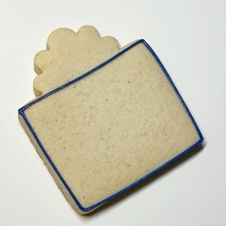 Step-by-step decorating instructions for how to decorate present cookies with royal icing