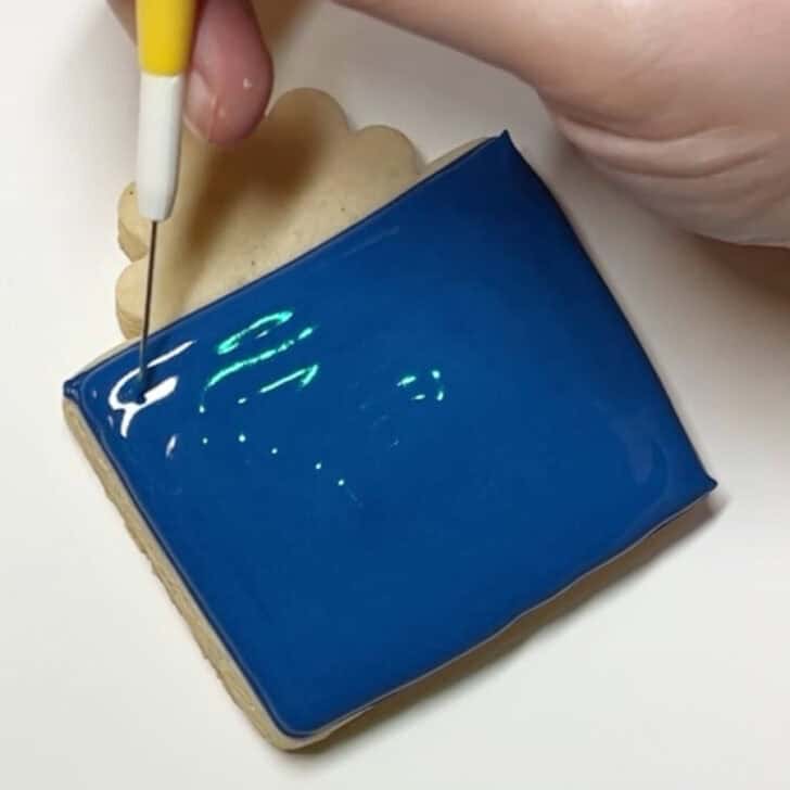 Step-by-step decorating instructions for how to decorate present cookies with royal icing